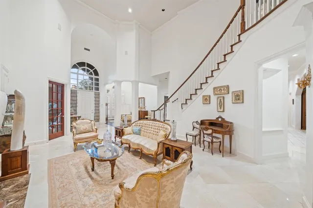 a dining room with furniture a chandelier and wooden floor