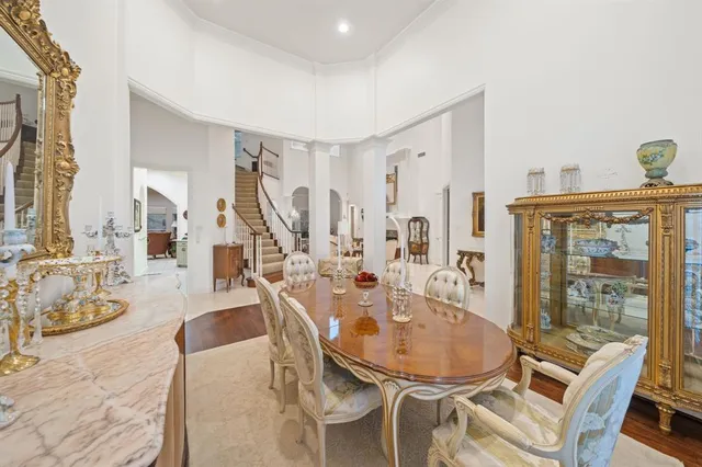 a view of a dining room with furniture and a chandelier