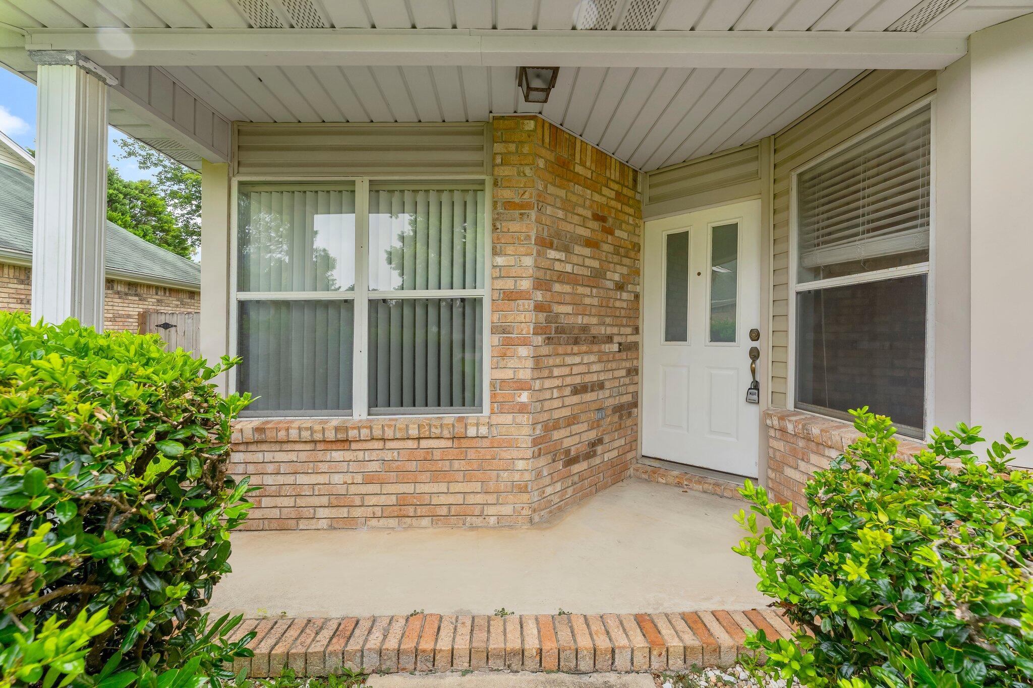 1329 White Blossom Lane Fort Walton Beach, FL 32547 - Photo 27 of 27 a front view of a house with a porch