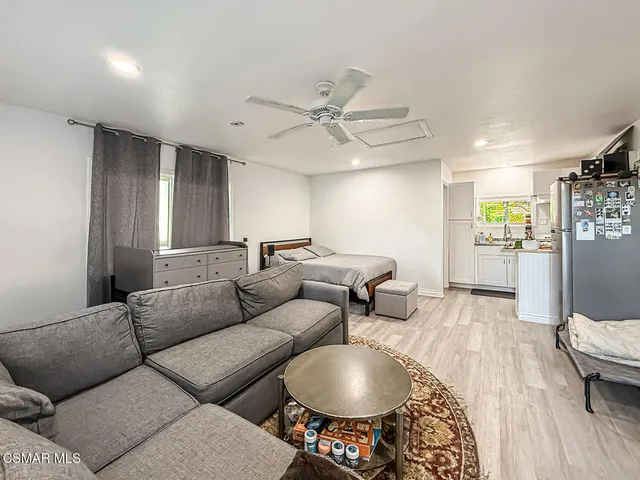 a kitchen with a sink a refrigerator and white appliances