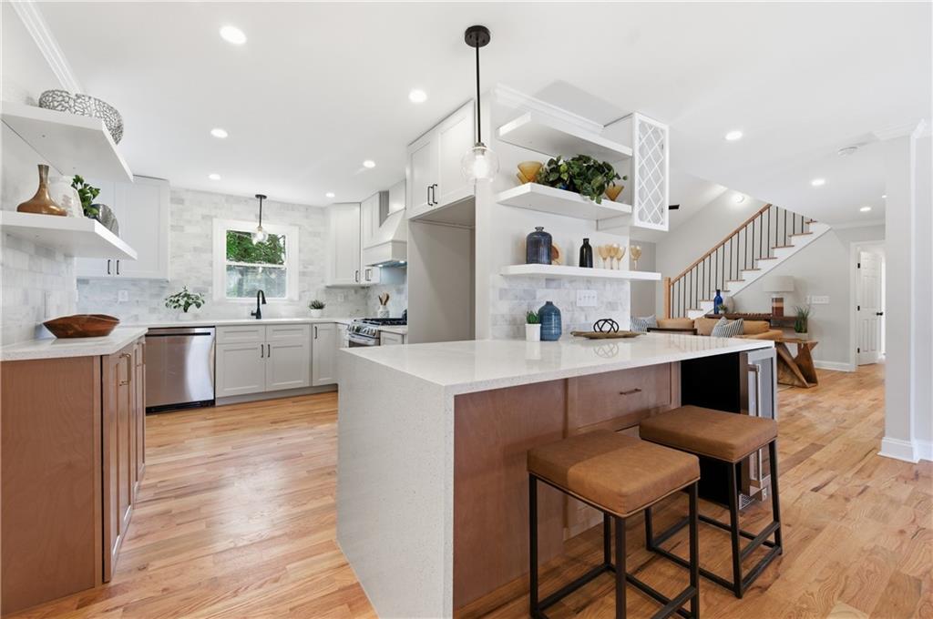 3571 Midvale Forest Court Tucker, GA 30084 - Photo 12 of 53 a kitchen with a sink a counter top space and stainless steel appliances