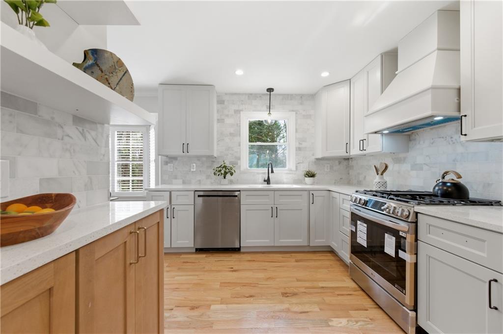 3571 Midvale Forest Court Tucker, GA 30084 - Photo 13 of 53 a kitchen with granite countertop a sink a counter space appliances and cabinets