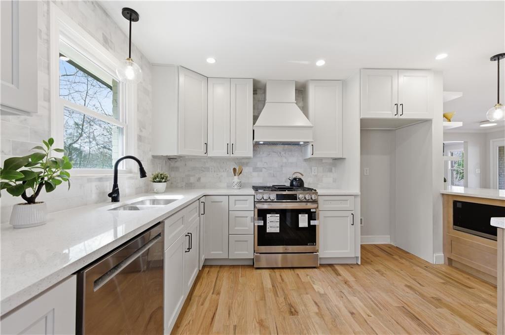 3571 Midvale Forest Court Tucker, GA 30084 - Photo 14 of 53 a kitchen with a sink stainless steel appliances and cabinets
