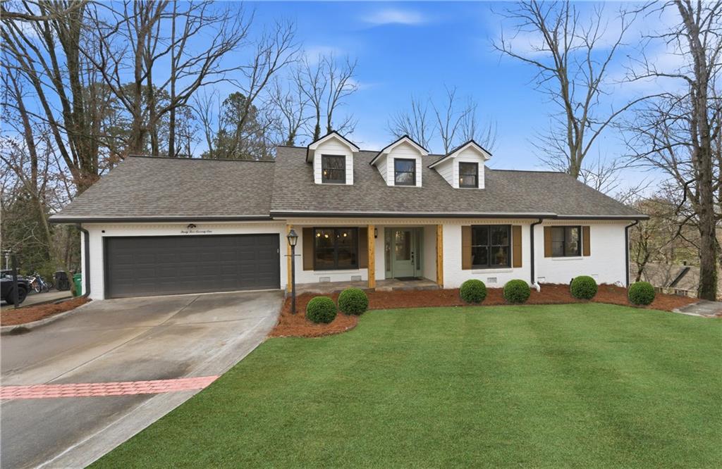 3571 Midvale Forest Court Tucker, GA 30084 - Photo 2 of 53 a front view of a house with a yard and garage