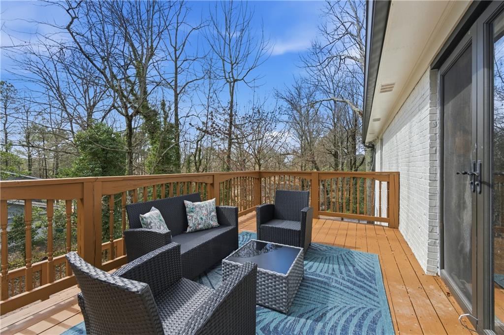 3571 Midvale Forest Court Tucker, GA 30084 - Photo 26 of 53 a balcony with wooden floor and outdoor seating
