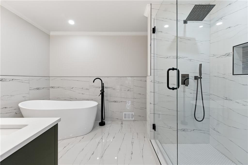 3571 Midvale Forest Court Tucker, GA 30084 - Photo 29 of 53 a bathroom with a sink a mirror and a shower