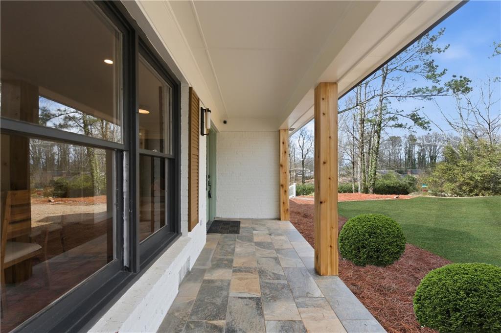 3571 Midvale Forest Court Tucker, GA 30084 - Photo 3 of 53 a view of a brick house with a large windows