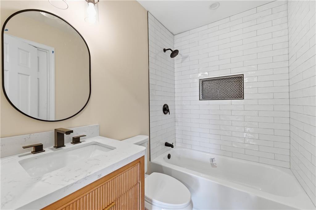 3571 Midvale Forest Court Tucker, GA 30084 - Photo 33 of 53 a bathroom with a sink a toilet and a mirror