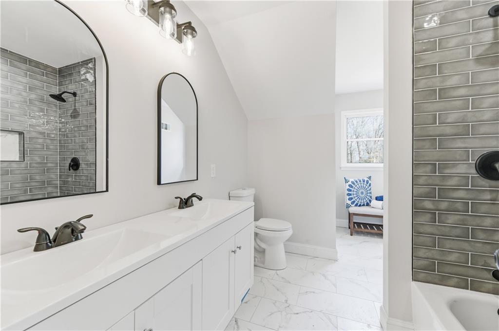 3571 Midvale Forest Court Tucker, GA 30084 - Photo 36 of 53 a bathroom with a double vanity sink toilet and shower