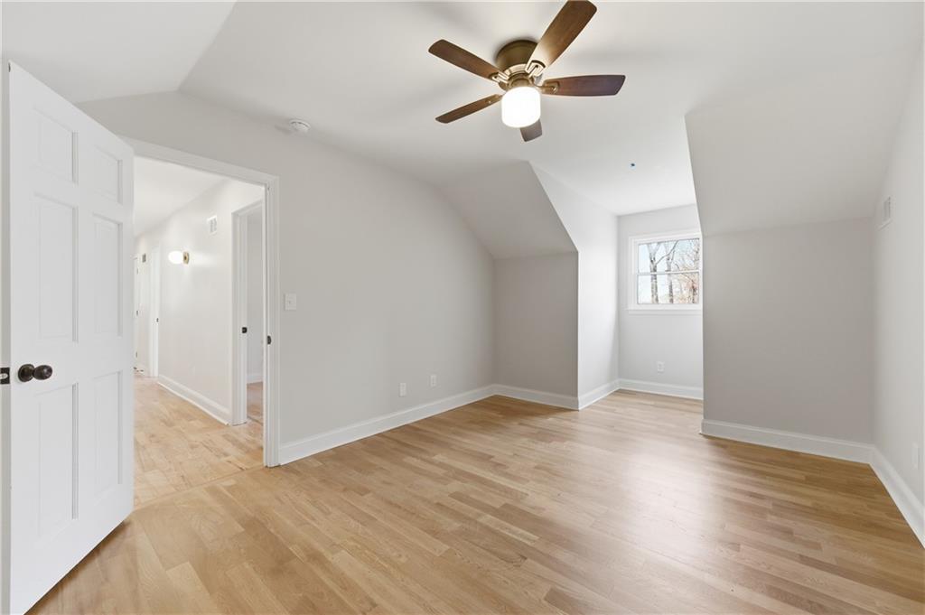 3571 Midvale Forest Court Tucker, GA 30084 - Photo 38 of 53 an empty room with wooden floor fan and windows