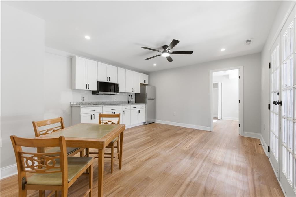 3571 Midvale Forest Court Tucker, GA 30084 - Photo 42 of 53 a view of a dining room with furniture and wooden floor