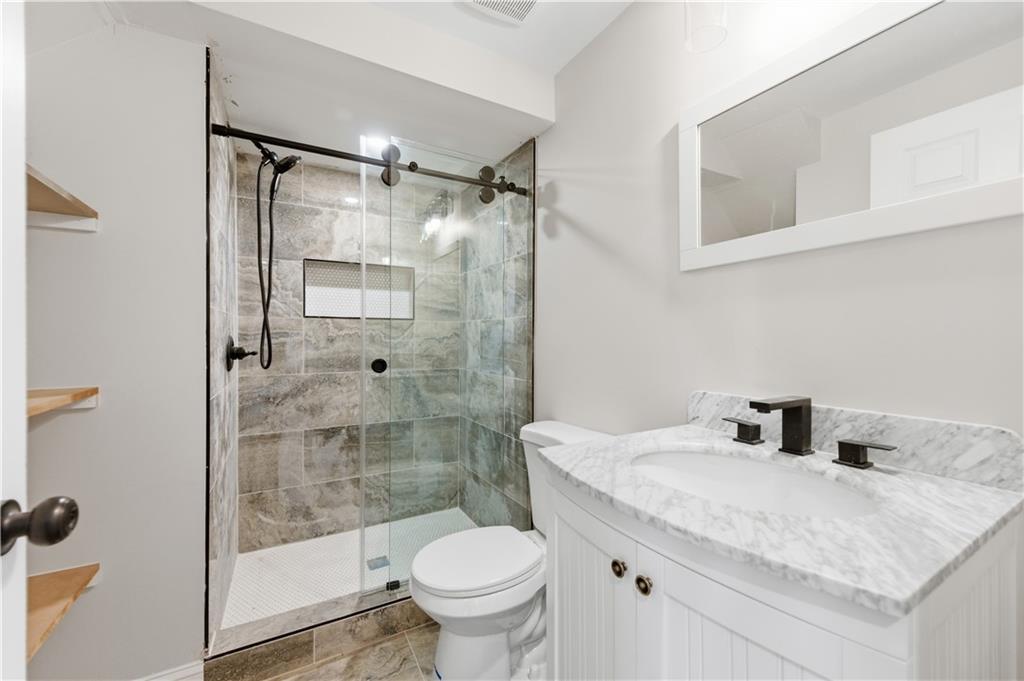 3571 Midvale Forest Court Tucker, GA 30084 - Photo 43 of 53 a bathroom with a granite countertop sink toilet and shower