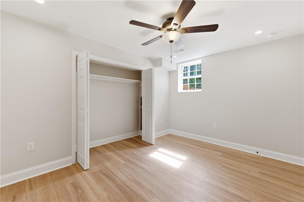 3571 Midvale Forest Court Tucker, GA 30084 - Photo 44 of 53 an empty room with wooden floor and ceiling fan