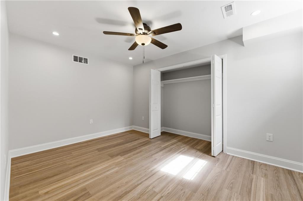 3571 Midvale Forest Court Tucker, GA 30084 - Photo 45 of 53 a view of an empty room with wooden floor and a ceiling fan