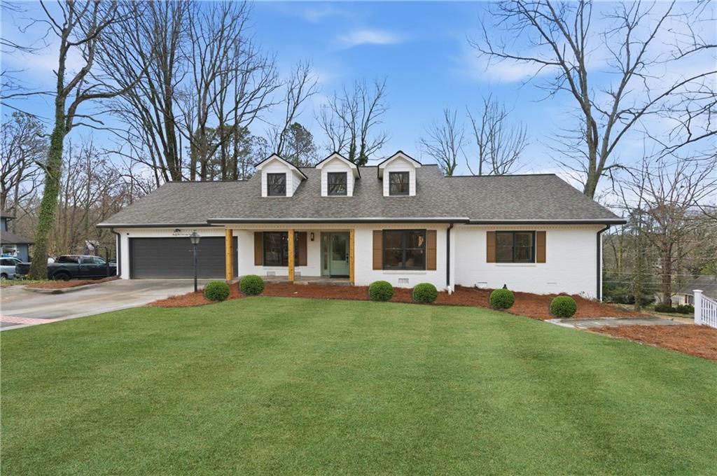 3571 Midvale Forest Court Tucker, GA 30084 - Photo 49 of 53 a front view of a house with a garden and trees