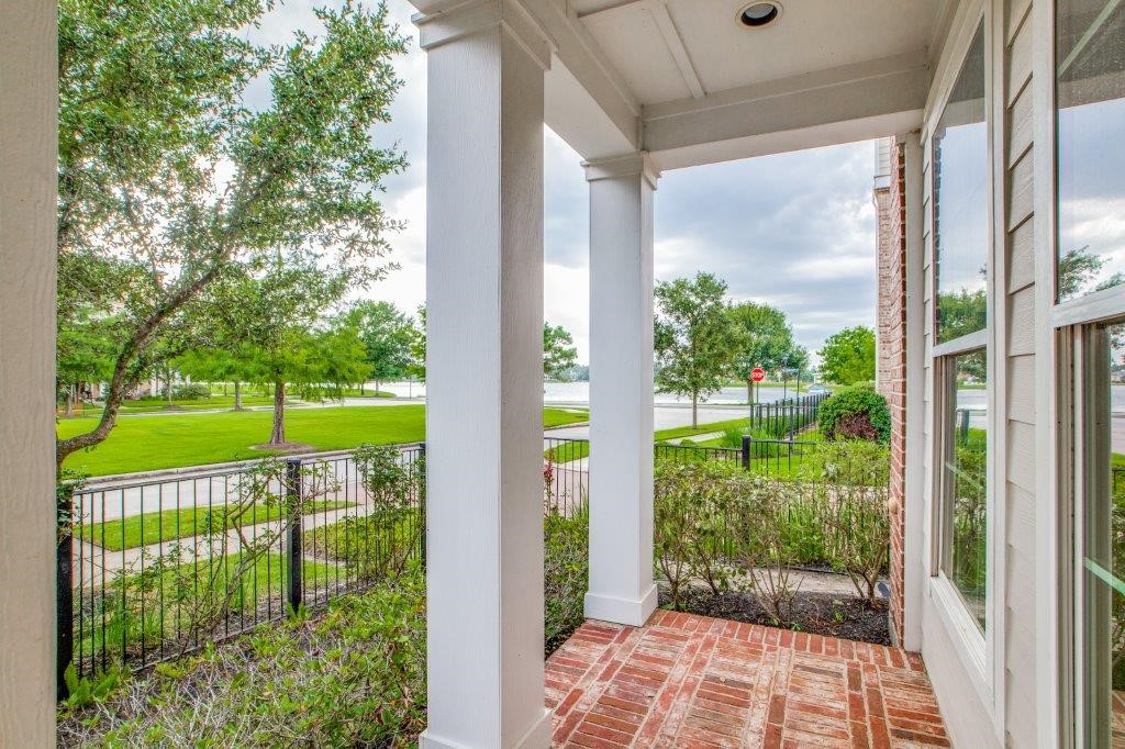 46 East Rafters Row The Woodlands, TX 77380 - Photo 23 of 25 Charming covered front porch overlooking beautifully landscaped East Shore streets.