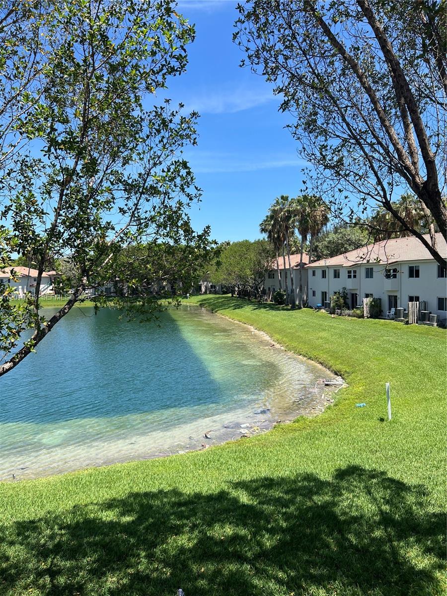 2931 Southeast 12th Road, Unit 20455 Homestead, FL 33035 - Photo 12 of 12 a view of yard with swimming pool and green space