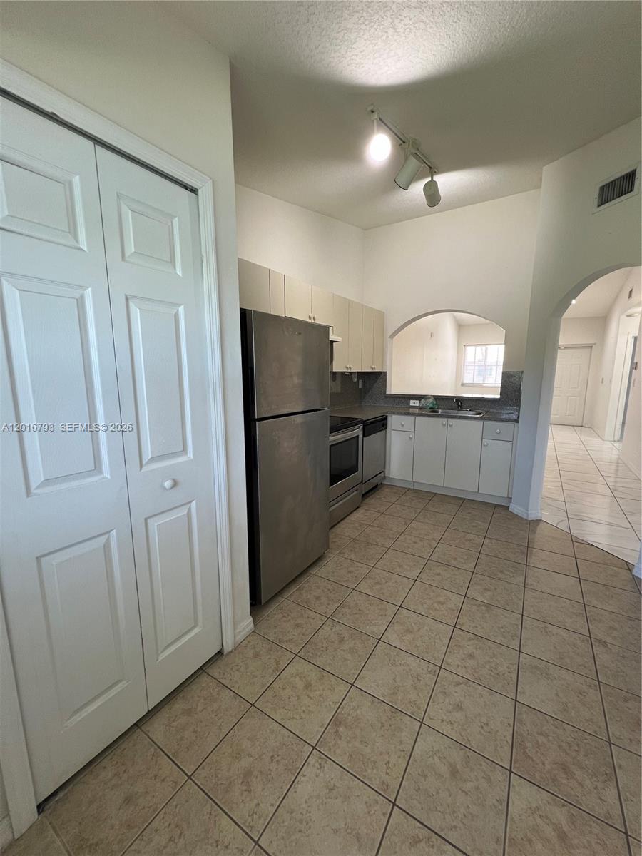 2931 Southeast 12th Road, Unit 20455 Homestead, FL 33035 - Photo 5 of 12 a kitchen with stainless steel appliances a refrigerator and a sink