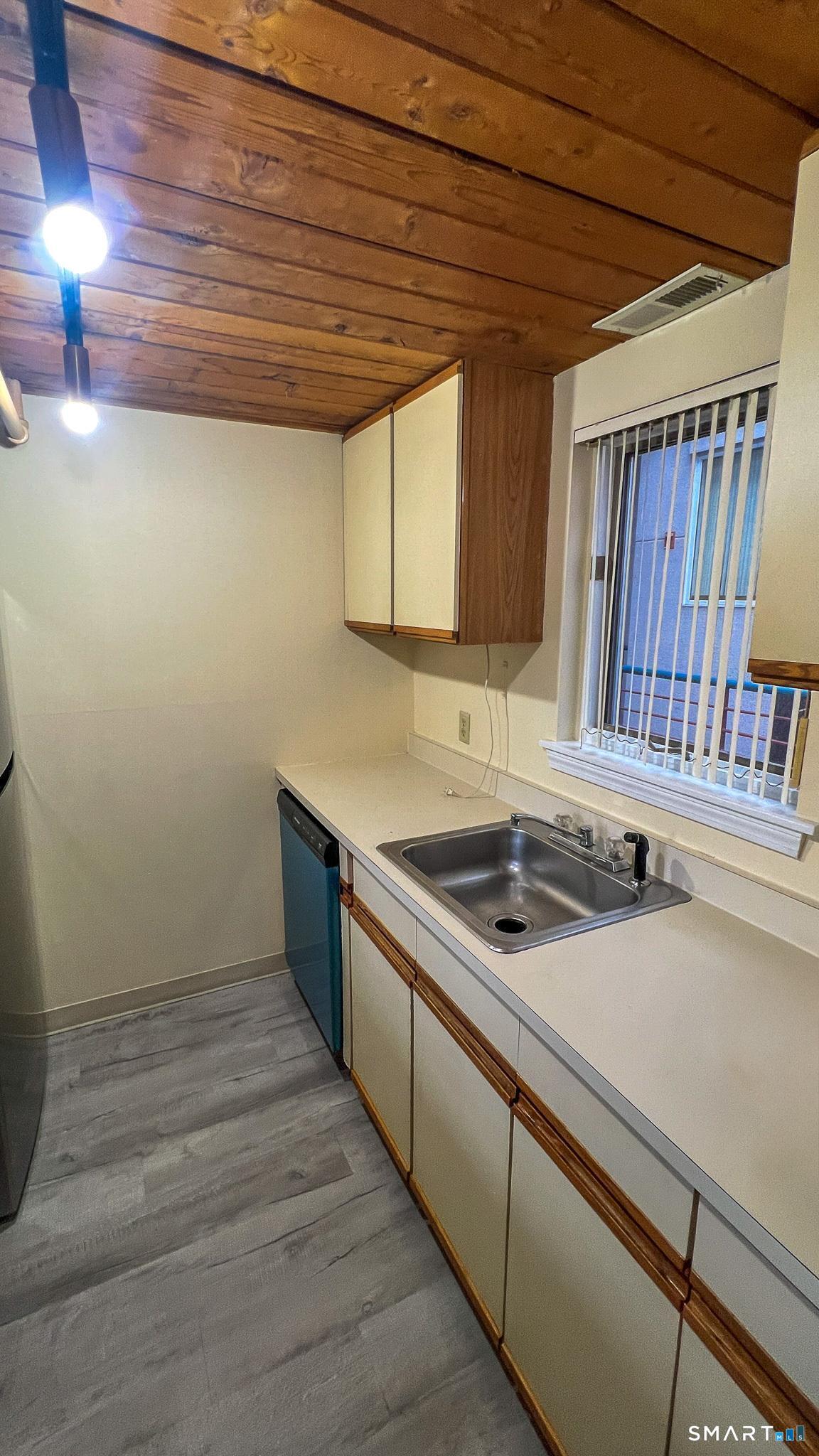 839 Main Street, Unit 68 Torrington, CT 06790 - Photo 11 of 20 a kitchen with a sink and cabinets