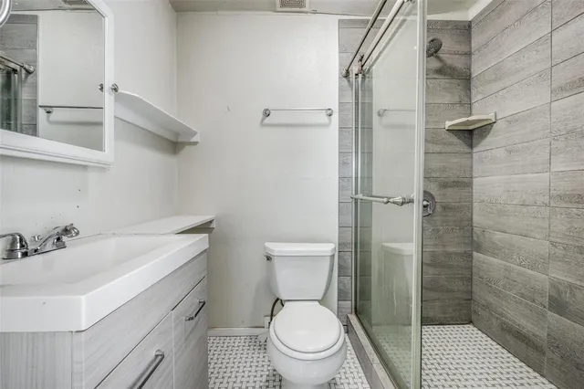 a bathroom with a toilet a sink and shower