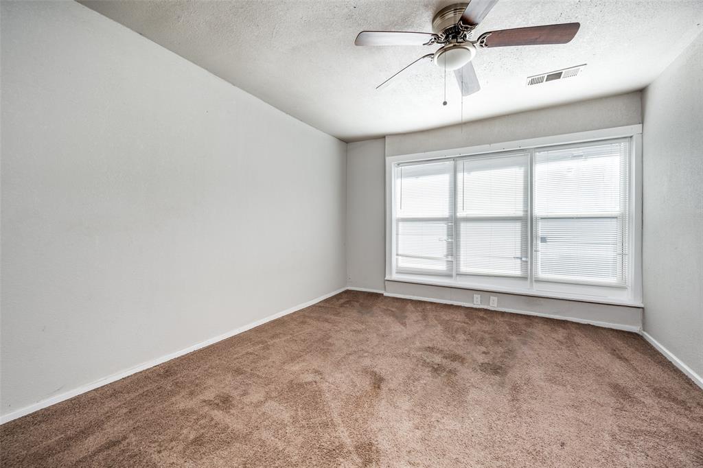 701 Lakey Street Denton, TX 76205 - Photo 18 of 25 an empty room with windows and fan