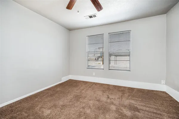 an empty room with windows and closet