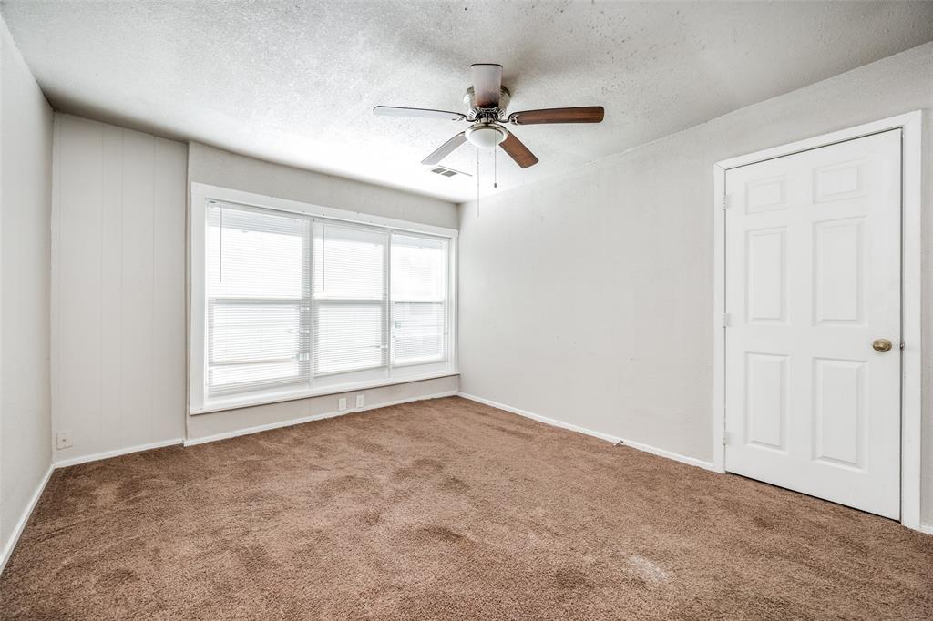 701 Lakey Street Denton, TX 76205 - Photo 21 of 25 an empty room with windows and fan