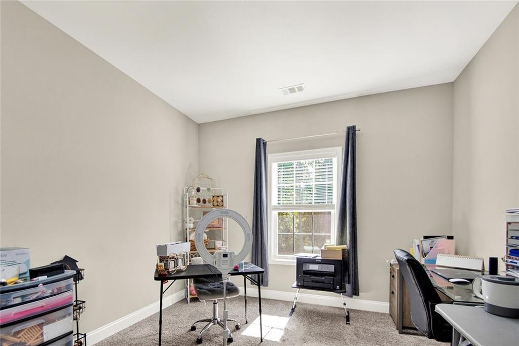 407 Corinth Church Road Winder, GA 30680 - Photo 56 of 66 a view of a workspace with furniture and a window