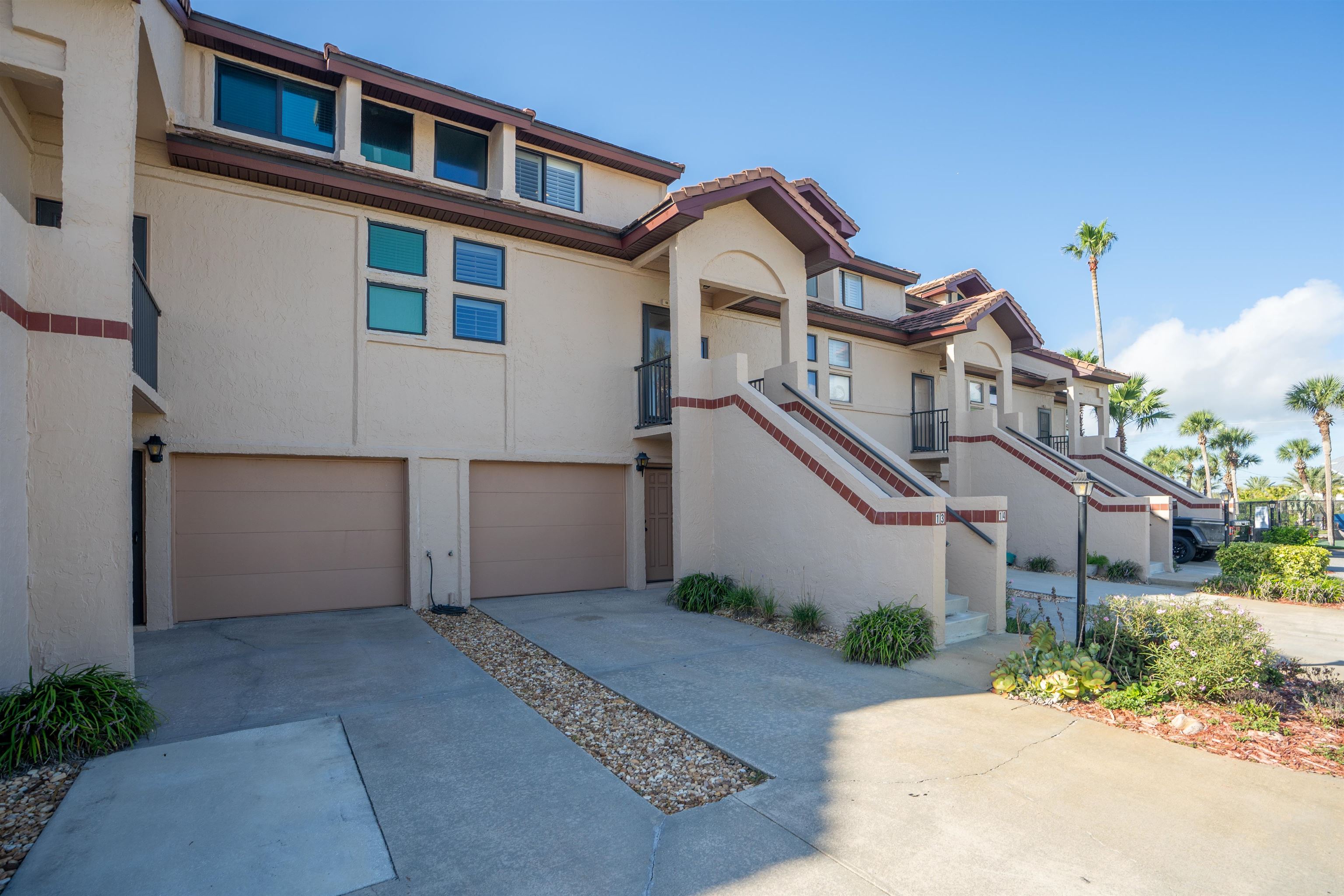 8200 A1A South, Unit 13 St. Augustine, FL 32080 - Photo 30 of 56 a front view of a house with a yard