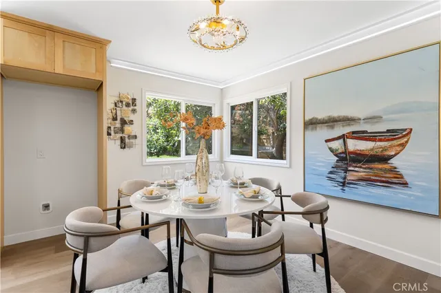 a dining room with furniture a rug and a large window