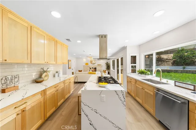 a kitchen with stainless steel appliances kitchen island granite countertop a sink and cabinets