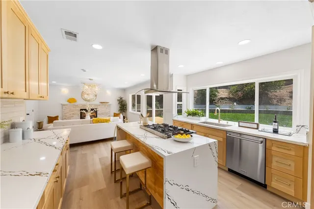 a large kitchen with kitchen island granite countertop a large window