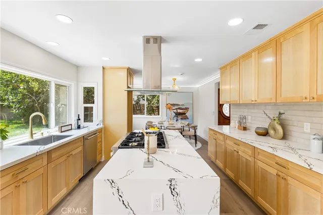 a kitchen with stainless steel appliances granite countertop a stove and a sink
