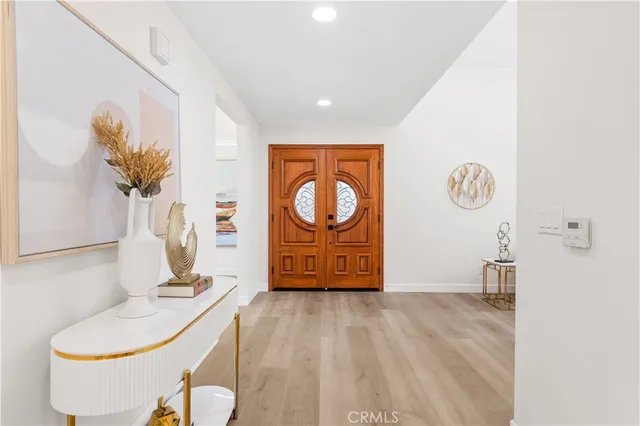 a living room with furniture and a painting on the wall