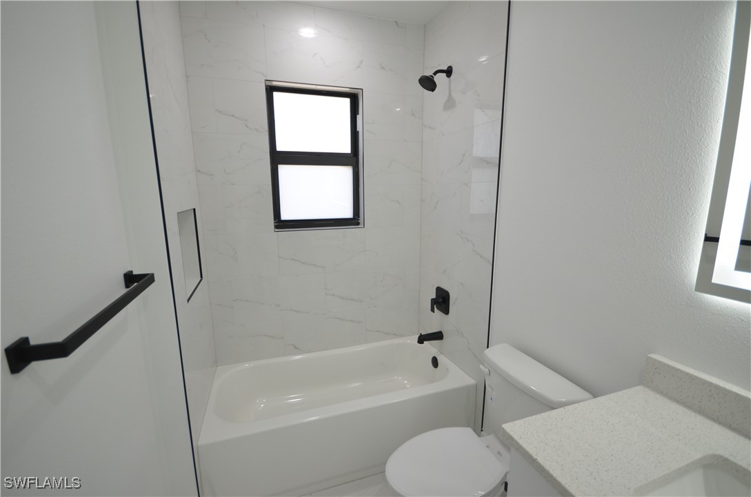 2132 Barker Boulevard Fort Myers, FL 33916 - Photo 12 of 36 a bathroom with a toilet and a bath tub