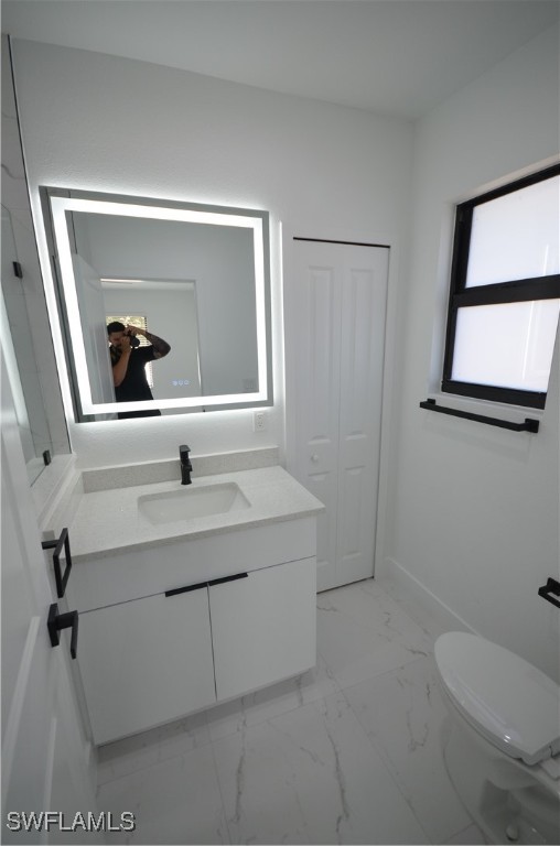 2132 Barker Boulevard Fort Myers, FL 33916 - Photo 23 of 36 a bathroom with a sink a toilet and mirror