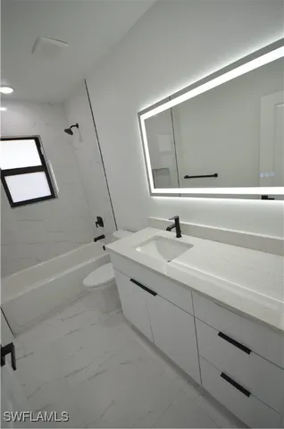 a bathroom with a sink a toilet and bathtub