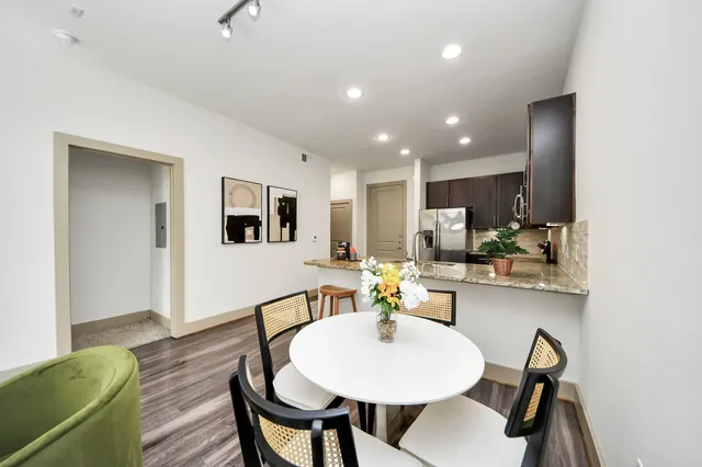 a kitchen with stainless steel appliances granite countertop a stove a sink and a refrigerator