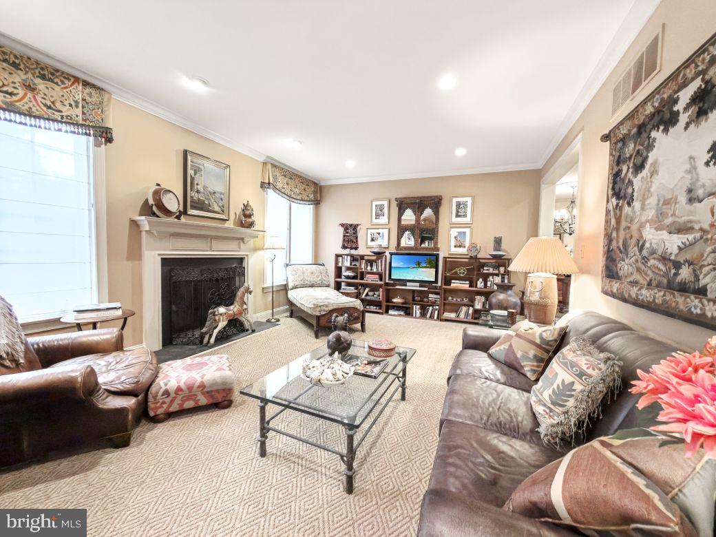 12 Chalous Lane Villanova, PA 19085 - Photo 12 of 39 a living room with furniture a fireplace and a large mirror with wooden floor
