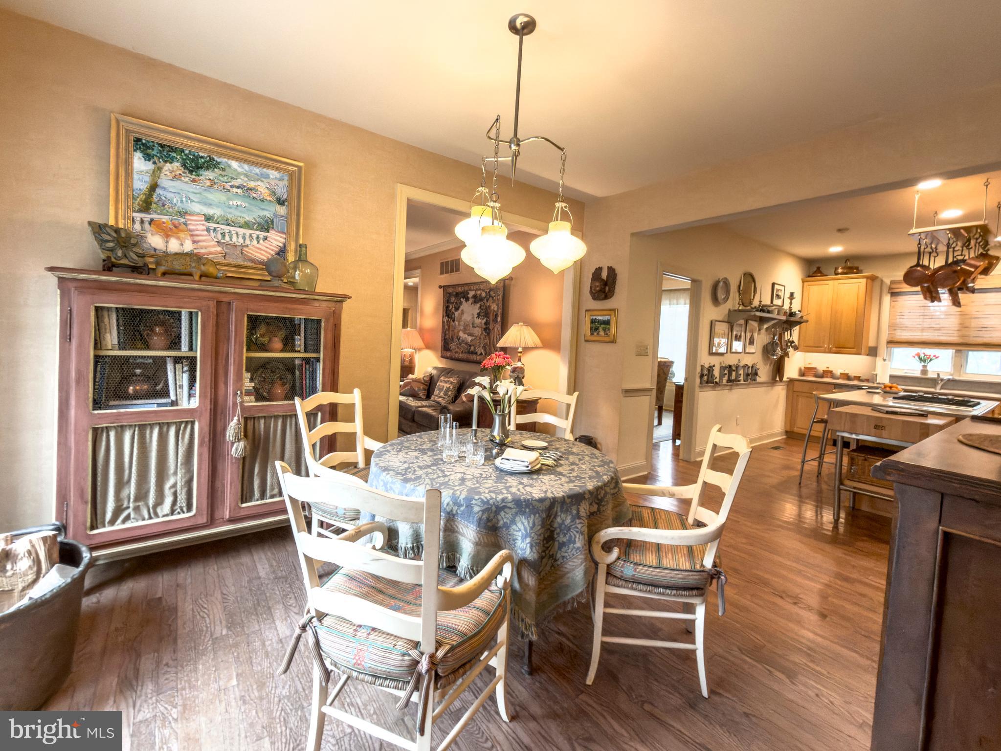 12 Chalous Lane Villanova, PA 19085 - Photo 14 of 39 a dining room with wooden floor a chandelier a wooden table and chairs