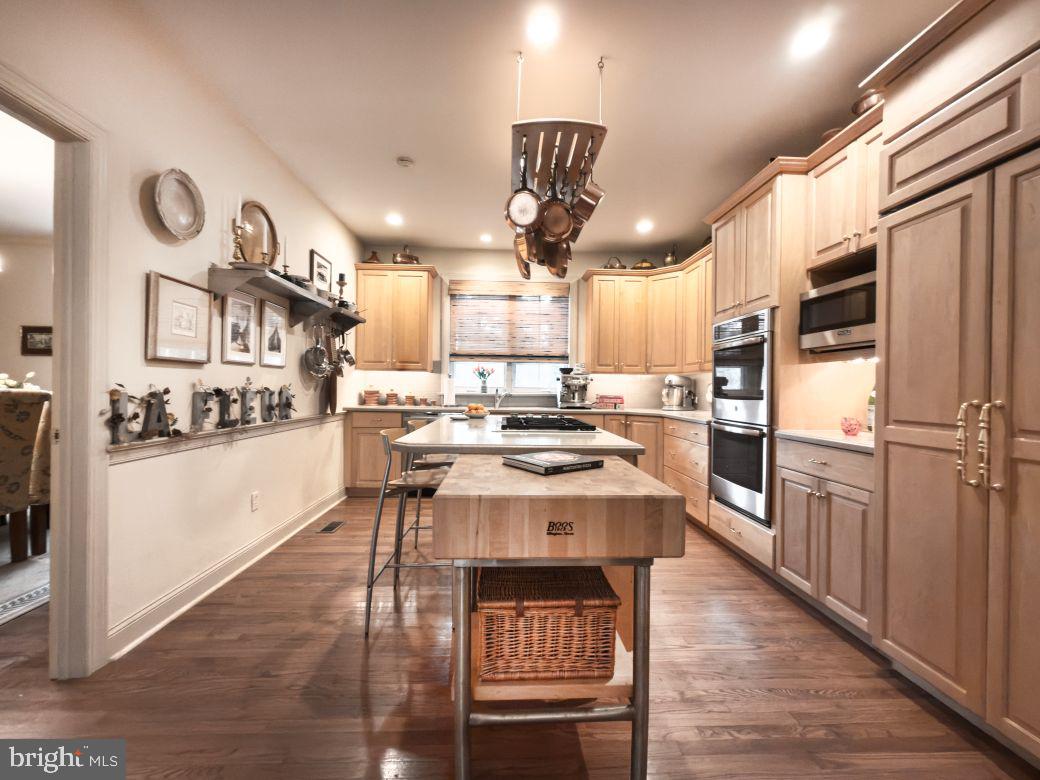 12 Chalous Lane Villanova, PA 19085 - Photo 18 of 39 a kitchen with stainless steel appliances granite countertop a refrigerator a sink dishwasher a stove and white countertops with wooden floor