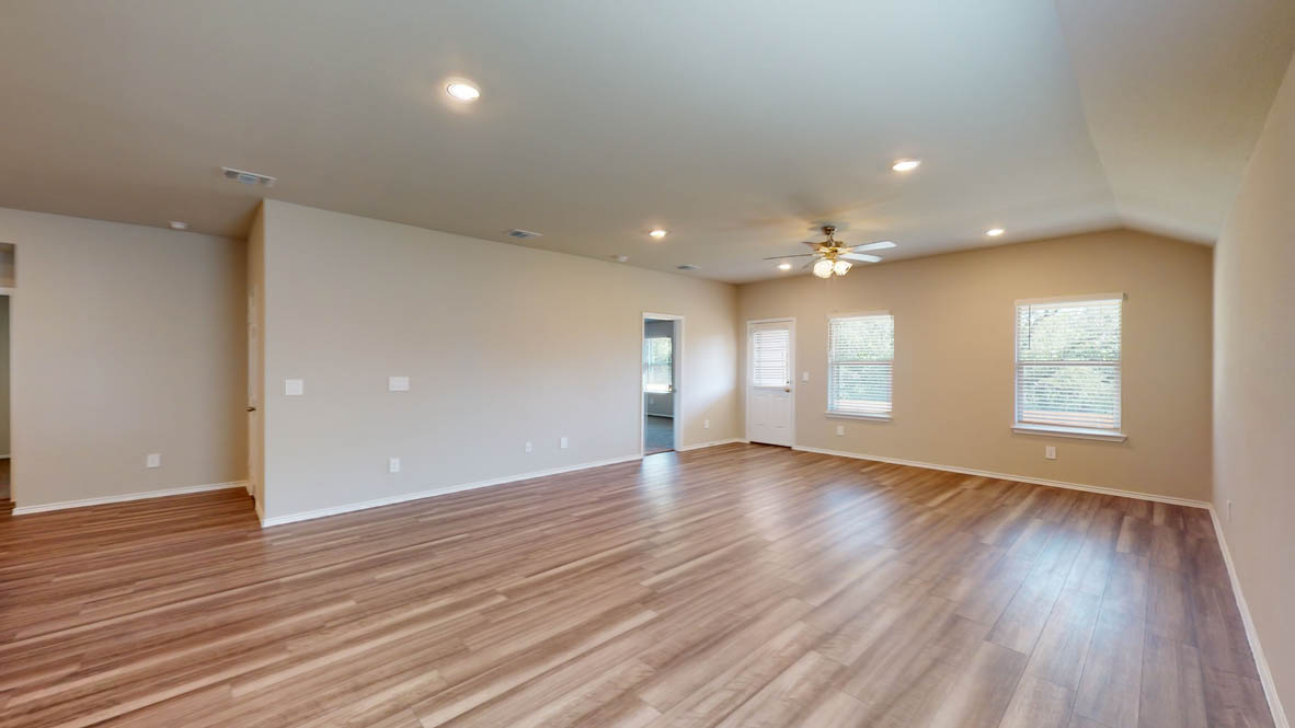 509 Hector Loop Georgetown, TX 78626 - Photo 11 of 31 A spacious living area featuring warm wood flooring and abundant natural light.