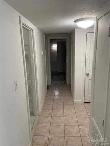 a view of hallway with a window and a mirror