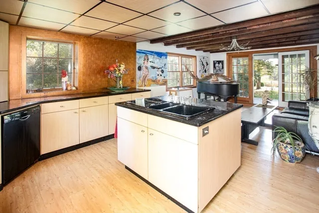 a kitchen with a stove a refrigerator and storage