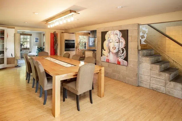 a dining room with furniture and wooden floor