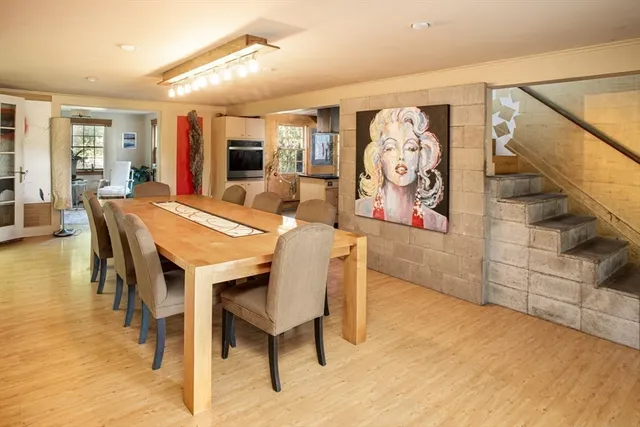 a dining room with furniture and wooden floor