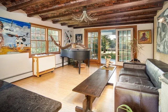 a living room with furniture a window and a flat screen tv