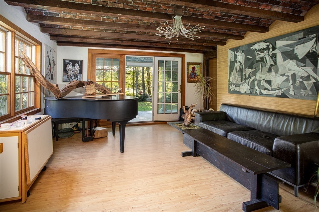 17 Quail Trail Westport, MA 02790 - Photo 22 of 40 a living room with furniture a window and a flat screen tv