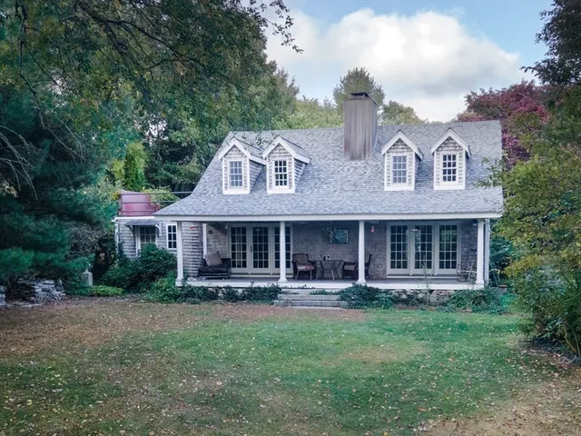 a front view of a house with a yard and porch
