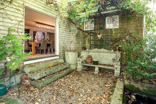 a backyard of a house with a yard and outdoor seating